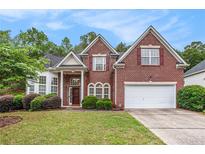 Charming brick home with a well-manicured lawn and lush landscaping at 3185 Highgreen Trl, Atlanta, GA 30349