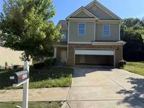Charming two-story home with a two-car garage and a well-maintained lawn in a suburban neighborhood at 4287 Traipse Path, Ellenwood, GA 30294
