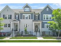Charming townhomes with gray and white brick, black trim, fenced yards, and well-manicured landscaping at 2744 Bell Se Dr, Smyrna, GA 30080