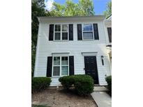 Charming townhome with white siding, black shutters, and well-maintained landscaping at 1700 Devon Sw Dr, Atlanta, GA 30311