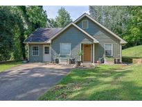 Charming single-Gathering home featuring a well-maintained lawn and ample parking space at 1650 Tomahawk Trl, Cumming, GA 30041