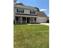 Charming two-story home with a welcoming front porch and well-manicured lawn at 421 Old Ivy Path, Mcdonough, GA 30253