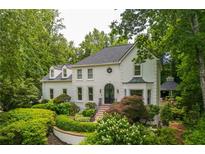 Stunning two-story home with a black door, pristine white exterior, and expertly landscaped front yard at 341 Lands Se Ml, Marietta, GA 30067