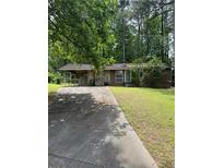 Charming single-story home with stone accents, a covered parking area, and a lush green lawn at 1234 Carolyn St, Marietta, GA 30062