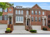Charming brick townhomes feature well-maintained landscaping and inviting entrances at 2513 Friar Tuck Se Ln # 1, Atlanta, GA 30339
