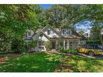 Charming home with a manicured lawn and inviting curb appeal and vintage yellow car at 2517 Birchwood Ne Dr, Atlanta, GA 30305