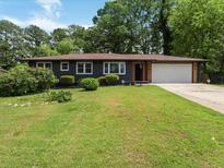 Charming single-story home featuring a well-manicured lawn and inviting curb appeal with a garage at 3779 Elkridge Dr, Decatur, GA 30032