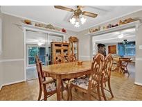 Traditional dining room with wood table, chairs, parquet floors and display shelves with decorative items at 200 Dogwood Dr, Canton, GA 30114