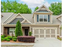 Charming home featuring a two-car garage and beautifully landscaped front yard at 1555 Water Vista Ct # 4102, Cumming, GA 30041