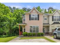 Charming townhome with lush green landscaping and a private parking area at 7331 Wagon Wheel Ct, Jonesboro, GA 30236