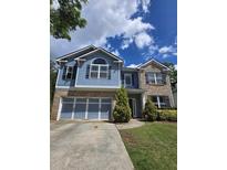Charming two-story home with a brick and siding facade, blue accents, and well-manicured lawn at 133 Parkway Dr, Fairburn, GA 30213