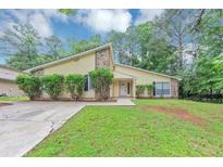 Charming home with a well-maintained lawn, complemented by lush greenery and trees at 6350 Mozart Dr, Riverdale, GA 30296