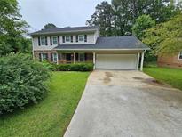 Charming two-story home with a well-maintained lawn and attached two car garage at 2860 Cocklebur Cove Ct, Decatur, GA 30034