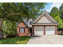 Charming two-story brick home with a two-car garage and a well-manicured lawn at 1620 Concord Meadows Dr, Smyrna, GA 30082