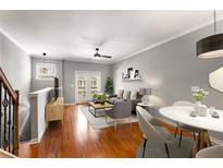 Bright living room featuring hardwood floors, modern furniture, and access to a private balcony at 2015 Liberty Nw Ct, Atlanta, GA 30318