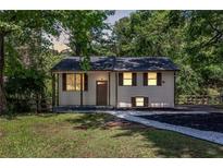 Charming home featuring a well maintained front yard, black roof, and brown trim at 2496 Shiloh Dr, Decatur, GA 30034