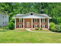 Charming brick home with covered porch and well-manicured lawn at 4361 Kimball Rd, Atlanta, GA 30331