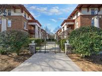 Brick building facade with gated entrance and professionally landscaped front yard at 746 N Highland Ne Ave # 7, Atlanta, GA 30306