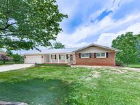 Charming brick home with a well-manicured front yard, covered porch, and attached garage at 104 Cochran Ridge Rd, Dallas, GA 30157