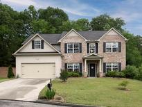 Charming two-story home with brick and siding, a well-manicured lawn, and an attached two-car garage at 5976 Rosie Se Ln, Mableton, GA 30126