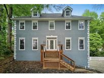 Charming two-story home with a symmetrical facade, a well-manicured yard, and a welcoming front porch at 1502 Lake Koinonia Dr, Woodstock, GA 30189