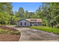 Charming single-story home with a well-manicured front yard and a welcoming driveway at 1997 N Landing Way, Marietta, GA 30066