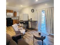 Open concept living area with modern finishes and plenty of natural light at 2021 Moody Drive Southwest, Atlanta, GA 30315
