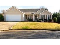 Charming single-story home with a well-manicured lawn, attached garage, and inviting entrance at 287 Pocono Nw Ct, Marietta, GA 30064