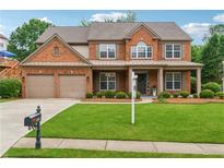 Charming two-story brick home with a well-manicured lawn and a two-car garage at 5281 Tormeall Trce, Suwanee, GA 30024