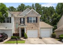 Charming townhome with a well-manicured lawn and an attached one car garage at 3313 Thornbridge Dr, Powder Springs, GA 30127