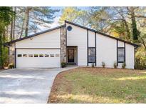 Charming single-Gathering home featuring a symmetrical front facade with a two-car garage and beautiful front yard at 3193 Deshong Dr, Stone Mountain, GA 30087