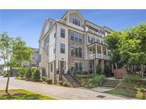 A contemporary townhome boasts a multi-level facade, brick accents, and manicured landscaping at 392 Concord St, Alpharetta, GA 30009