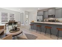 Open-concept kitchen featuring stainless steel appliances, gray cabinetry, and a central island with bar stool seating at 3142 Washburn St, Atlanta, GA 30354