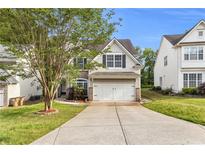 Charming two-story home featuring a well-manicured lawn, attached two car garage, and traditional design at 355 Pintail Ct, Suwanee, GA 30024