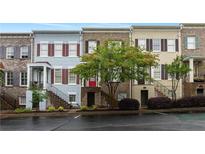 Charming townhomes featuring brick and siding exteriors, manicured landscaping and tree-lined street at 1003 Pearl Ne Pt, Sandy Springs, GA 30328