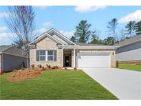 Charming single-story home with a well-manicured lawn, neutral brick facade, and a two-car garage at 470 Village Ln, Fairburn, GA 30213