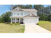 Charming two-story home with a well-manicured lawn and attached two-car garage at 20 Tarpley Way, Covington, GA 30016