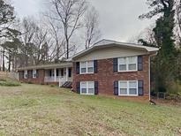 Charming brick two-story home featuring a landscaped yard and inviting front porch at 2550 Stoney Brook Ne Ln, Marietta, GA 30062
