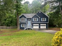 Charming two-story home with blue siding, white trim, and a well-manicured lawn at 4790 Brandon Acres Ln, Buford, GA 30519