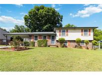 Charming ranch home featuring orange shutters and a well maintained lawn at 5791 Cobbrook Dr, Ellenwood, GA 30294