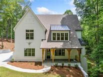 Charming white brick two-story home with covered porch and manicured landscaping at 2585 Hickory Rd, Canton, GA 30115