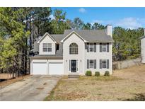 Charming two-story home featuring a two-car garage and well-maintained front yard at 4150 Soaring Dr, Douglasville, GA 30135