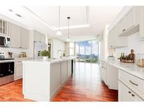 Bright kitchen features marble countertops, stainless steel appliances, a large island and views of the city skyline at 4561 Olde Perimeter Way # 2102, Atlanta, GA 30346