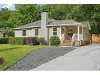 Charming exterior featuring a chimney, well-maintained lawn, and inviting front porch at 1605 Wellswood Se Dr, Atlanta, GA 30315
