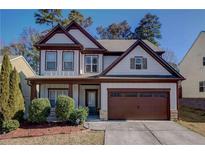 Charming two-story home with a well-maintained front yard and a two-car garage at 1761 Stoney Chase Dr, Lawrenceville, GA 30044