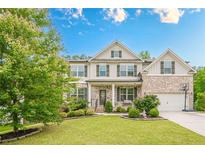 Charming two-story home featuring brick accents, a well-manicured lawn, and a welcoming front porch at 285 Turtle Rock Pl, Acworth, GA 30101