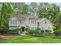 Charming two-story home features a well-manicured lawn and beautiful landscaping at 3780 Bays Ferry Way, Marietta, GA 30062