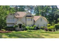 Charming two-story traditional home with manicured lawn and mature trees in a lush, green, landscaped setting at 3780 Bays Ferry Way, Marietta, GA 30062