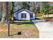 Charming home with a well-maintained lawn, long driveway, and classic mailbox at 141 Nathan Rd, Atlanta, GA 30331