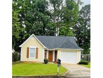 Charming yellow single-story home with an attached garage and well-manicured lawn at 3793 Mays Sw Ct, Atlanta, GA 30331